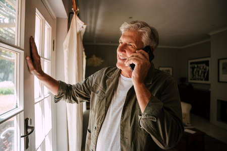 caucasian mature male on phone call smiling and happyの写真素材