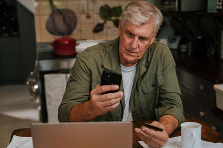 Caucasian elderly man stressed making online payment