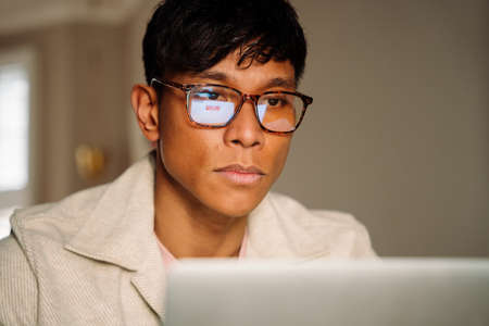 Asian Male working online with glassesの写真素材