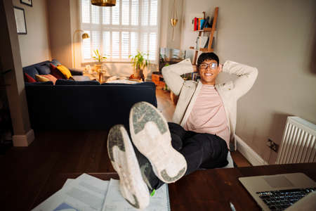 Asian male relaxed at desk