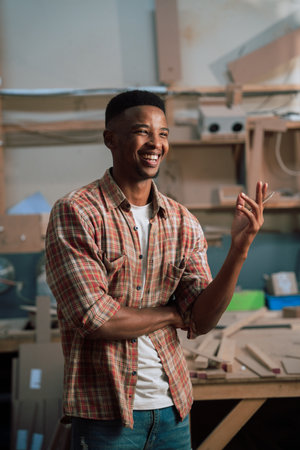 Confident smiling young African male trainee in factoryの写真素材