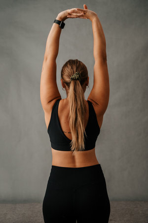 Close up Caucasian woman back view doing an arm stretchの写真素材