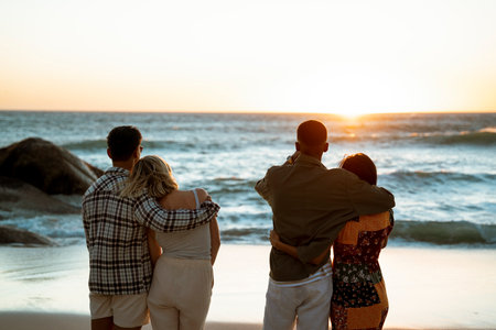 Couples at the Beach Enjoying the Sunsetの写真素材