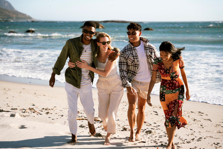 Four Friends Walking on the Beachの写真素材