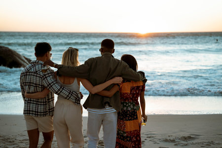 Friends on a Beach Watching the Wavesの写真素材