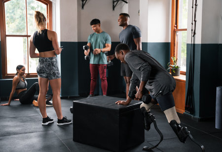 People gather around a box on the hardwood gym floor