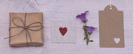 little present, a heart, a flower and a greeting tag in a rowの写真素材
