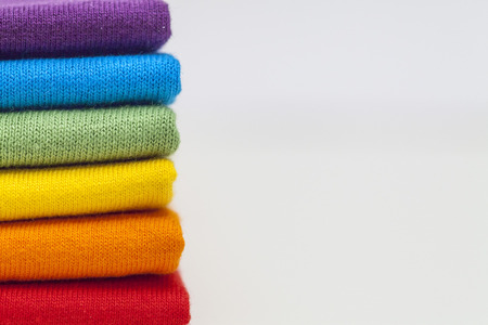 A stack of colourful shirts 