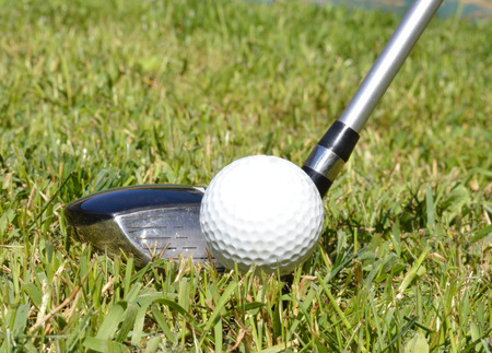 Golf ball, golf club on a fairwayの写真素材