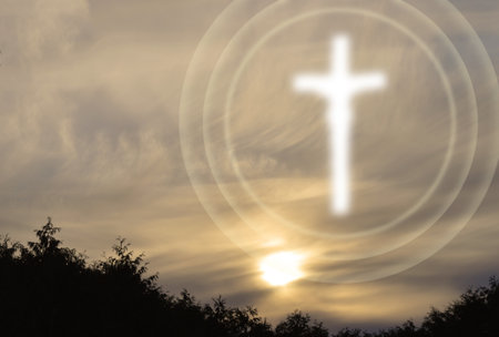 Cross in the sky at sunset with room for text on the sideの写真素材