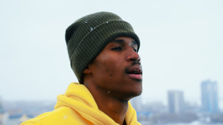 Man athlete in a bright sweater runs down the street in winterの写真素材