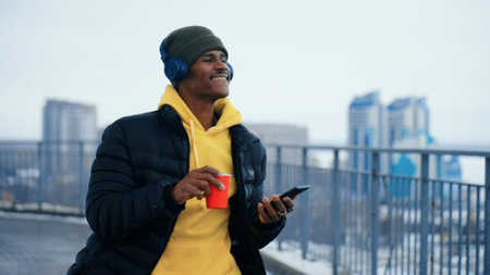 Man with headphones dancing in winterの写真素材