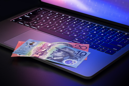 Australian dollar banknotes on laptopの写真素材