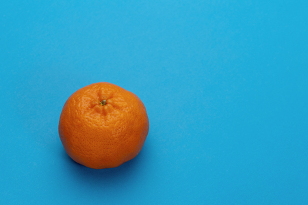 Mandarin, tangerine citrus fruit isolated on blue backgroundの写真素材