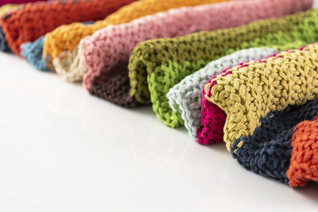 Wool blanket, colorful, knitted large chunky yarn. Close-up of knitted blanket on white background.の写真素材