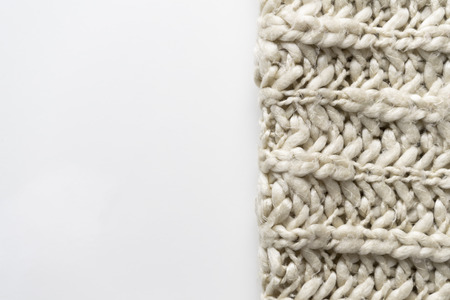 Wool blanket, white, knitted large chunky yarn. Close-up of knitted blanket on white background.の写真素材