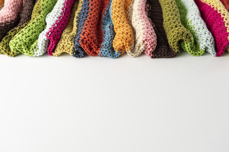 Wool blanket, colorful, knitted large chunky yarn. Close-up of knitted blanket on white background.の写真素材