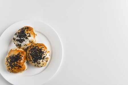 Chinese red bean paste cakes on ceramic plate, isolated on white backgroundの写真素材