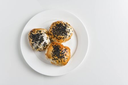 Chinese red bean paste cakes on ceramic plate, isolated on white backgroundの写真素材