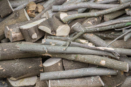 Close up of a pile of wooden logs, chopped into smaller pieces, timber logs.の写真素材