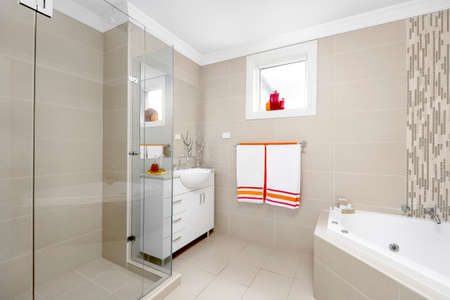 Interior of a modern bathroom with a shower, bathtub and a washbasin.の写真素材