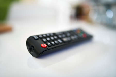 Close up of a TV remote on white background, shallow depth of the field.の写真素材