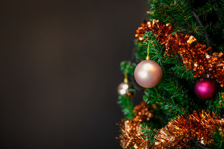 Decorated beautiful Christmas tree on blurred dark backgroundの写真素材