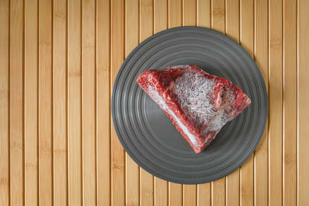 Piece of Wagyu beef on a plate with bamboo mat as a backgroundの写真素材