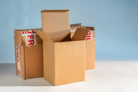 Empty cardboard box isolated on the blue and white backgroundの写真素材
