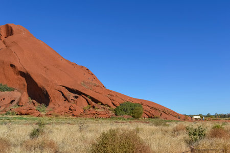 People climbing the Uluru, Ayers rock at Uluru Kata Tjuta National Park in Central Australian Desertの写真素材