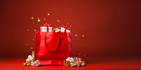 Santa claus bag full of gifts and decorations on red background, copy space. Merry Christmas shopping concept.の写真素材