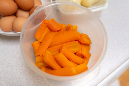 Eggs, potatoes, carrots and canned vegetables on the table. Ingredients for making a veggie saladの写真素材