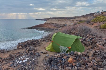 Green tent in front of the sea on the beach of Caleta de Adeje, Tenerife