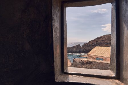 Window overlooking the sea from inside a marine lighthouse in Tenerife, Canary Islands, Spainの写真素材
