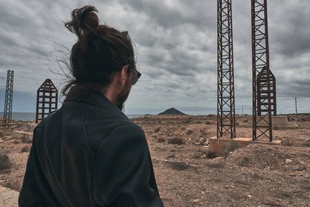 boys back in an industrial environment with abandoned antennasの写真素材