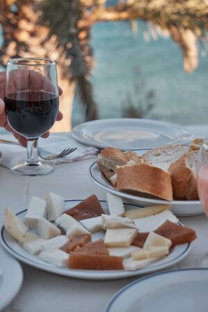 dinner preparation on a terrace with palm trees and sea viewsの写真素材