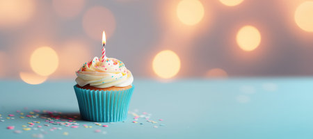 A cupcake with a lit candle on top of itの素材