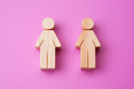 A couple of wooden people standing next to each otherの素材