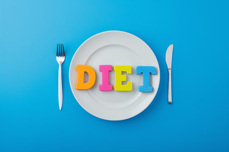 A creative and engaging image suitable for health and wellness magazines, nutritional blogs, or dietary service advertisements | This image presents a bold and simplistic statement about dieting and nutrition with multi-colored sponge letters spelling out "DIET" on a pristine white plate, set against a bright blue background. The letters, in vibrant shades of orange, pink, yellow, and blue, pop out, drawing immediate attention and suggesting a fun and approachable side to dieting. The plate, with its clean and unoccupied space, emphasizes the concept of portion control and mindful eating. On either side, a white fork and knife rest neatly, their polished surfaces reflecting discipline and the tools necessary for maintaining a healthy diet. The striking contrast of colors and the meticulous arrangement of this composition speaks to the idea of structure and balance in dietary choices. The ample negative space around the central elements provides a visual breather, reinforcing the theme of simplicity in meal planning and the mental clarity that a well-organized diet can contribute to | Perfect for visual aids in nutrition guides, this image can equally serve to complement articles focusing on weight management, or as an eye-catching graphic for diet planning apps. It can also act as an engaging print for kitchen decor or a visual prompt for health-focused workshops and seminars | a neatly staged photo of alphabet sponge letters on a plate, with eating utensils on the side, against a uniform background that allows for focus on the theme of diet and nutritionの素材