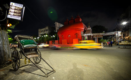 Tradition or symbol of North Kolkata is Red Temple, Yellow Taxi(in motion bluer)  and hand pulled rikshaw. In this image all are at same frame. 28th august 2022のeditorial素材