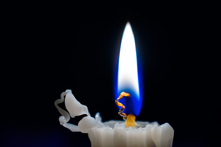 The candle burns in the darkの写真素材