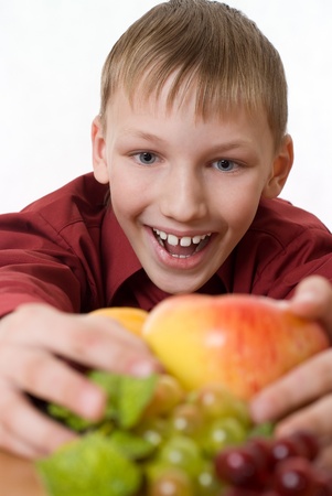 boy pulls himself to the fruitの写真素材