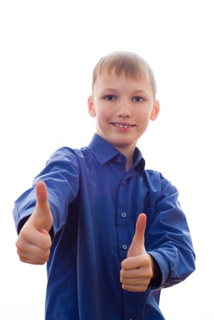handsome boy in a blue shirt stands and smilesの写真素材