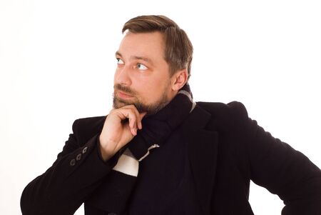 man in a black coat thinking on a whiteの写真素材