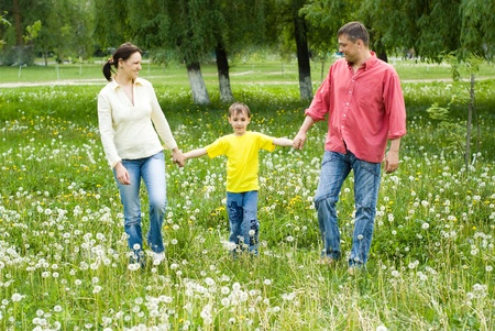 portrait of a happy family of three on the natureの写真素材