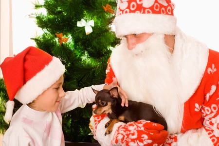 Santa gives presents to child on a white backgroundの写真素材