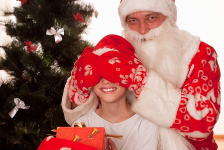 Santa gives presents to child on a whiteの写真素材