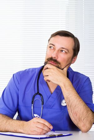 nice doctor sitting on the white backgroundの写真素材