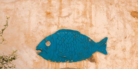 Close up picture of fish symbol on a traditional Berber house wall in Matmata, Tunisiaの写真素材