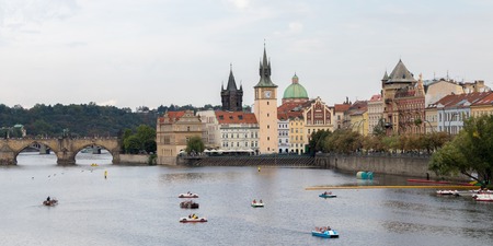 Prague, cityscape with bridge and boats on Vltava river
